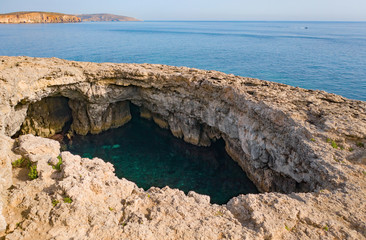 Big natural hole in the rock. Coral Lagoon in Mellieha. Malta island