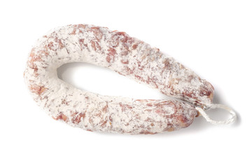 Delicious dry sausage on a white background.