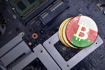 golden bitcoins with flag of oman on a computer electronic circuit board. bitcoin mining concept.