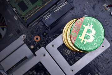 golden bitcoins with flag of turkmenistan on a computer electronic circuit board. bitcoin mining...