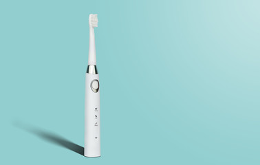 White sonic toothbrush for cleaning teeth on a blue pastel background. Medical and dental concept....