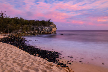 Coloful sunset and cliff at Shipwrecks Beach on Kauai island of Hawaii.