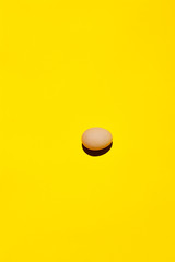 An egg. An egg on a yellow background. Egg background close-up. Egg texture wallpaper. Top view. Concept for designers copy space. An egg and only egg.