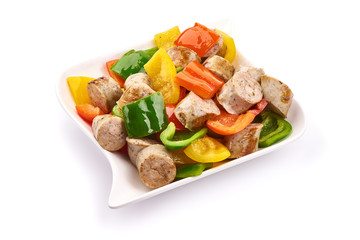 Fried Bavarian sausages with bell peppers, close-up, isolated on white background