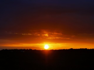 Obraz premium sunset over green meadow on the island Rügen with copy space