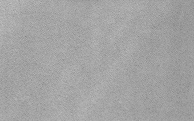 Plastered, painted, rough and gray concrete or stone wall in black and white. High resolution full frame textured background.