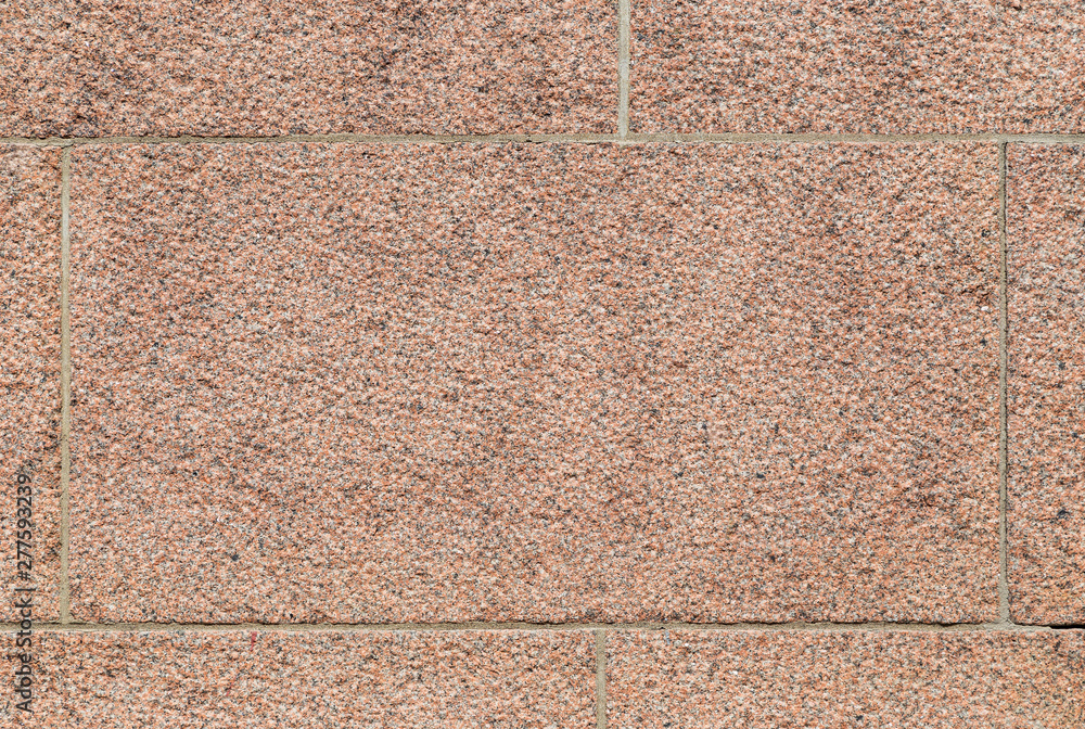 Poster close-up of part of a bumpy red granite block stone wall. high resolution full frame background text