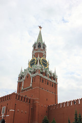 Fototapeta na wymiar Kremlin tower and wall on Red square, main square of russian capital - Moscow city on cloudy day. Majestic Kremlin building on dramatic sky background 