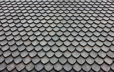 Black roof tile pattern. Dark roof design with modern wooden dark grey clad with shingles
