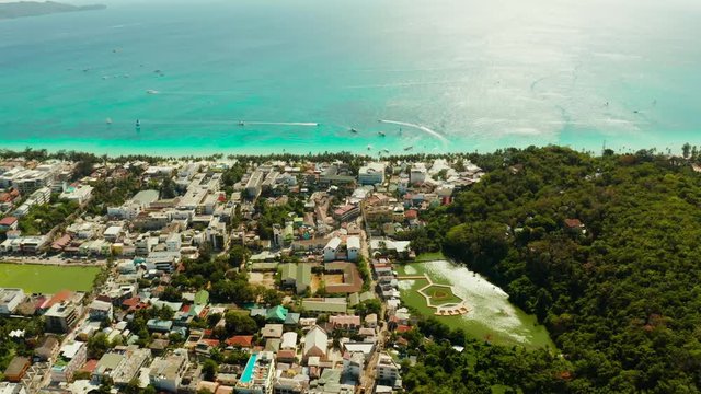 Tropical white sand beach, hotels near the blue lagoon and corall reef. aerial view, Boracay, Philippines. Seascape with beach on tropical island. Summer and travel vacation concept.