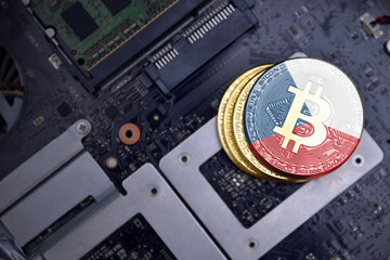 golden bitcoins with flag of czech republic on a computer electronic circuit board. bitcoin mining...