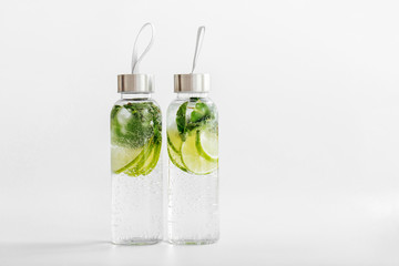 Fresh lime and mint infused water, cocktail, detox drink, lemonade in reusable bottles. Summer...