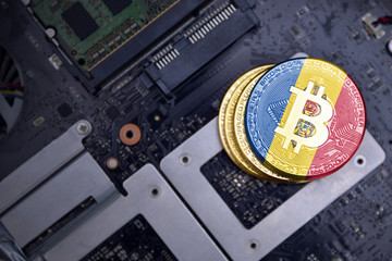 golden bitcoins with flag of moldova on a computer electronic circuit board. bitcoin mining concept.