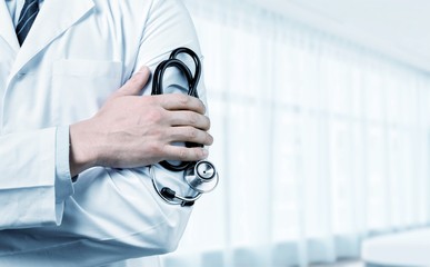 Young man doctor holding stethoscope