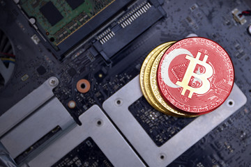 golden bitcoins with flag of turkey on a computer electronic circuit board. bitcoin mining concept.
