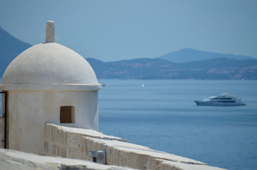 Fototapeta na wymiar White tower at sea background