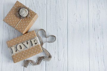 Two gift boxes on a light wooden background with a place for Copispeys. Frame for greeting text with boxes of gifts. Congratulations on the New Year, Mother's Day, Valentine's Day