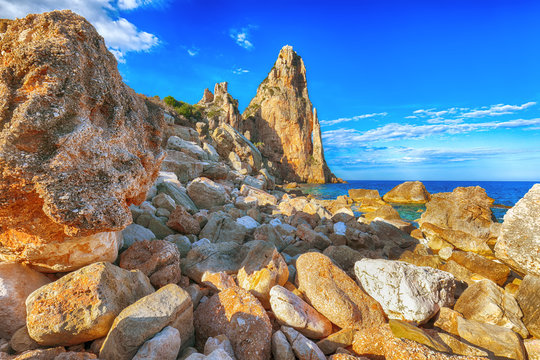 Spectacular view of Punta Pedra Longa and azure water in sea.