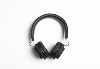 Stylish modern headphones on white background, top view