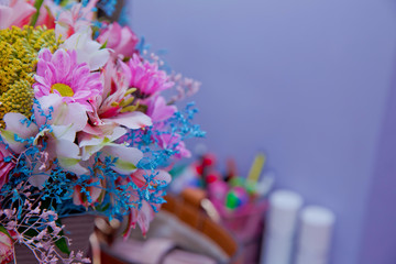 Bouquet of multicolored roses . Pink flower picture close up in the bouquet. Ribbon . Bouquet of fresh Pink, white , blue, orange roses .