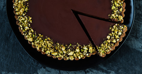 dark chocolate tart with pistachio topping