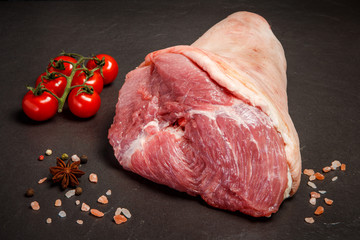 closeup big raw leg with meat with spices and tomatoes