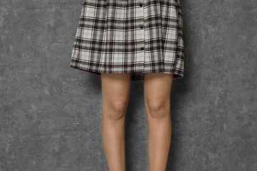 Young woman on grey background, closeup. Stop violence
