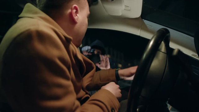 Shot inside in car gangster with gun attacked a man at night street thief lady criminal assault bandit burglar danger dangerous parking people risk rob robber desperation armed auto illegal pistol