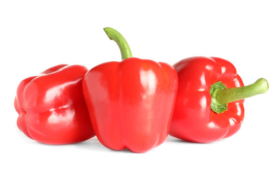 Tasty ripe red bell peppers on white background
