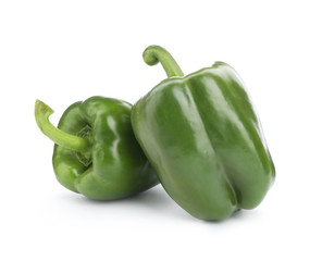 Ripe green bell peppers on white background