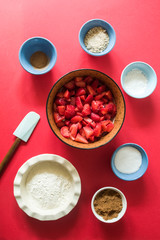 Ingredients to  to prepare  crunchy strawberries crumble, flour, strawberries, sugar brown, corn starch, cinnamon powder, salt, sugar white,  and Round and oval pirofila,see the other photos