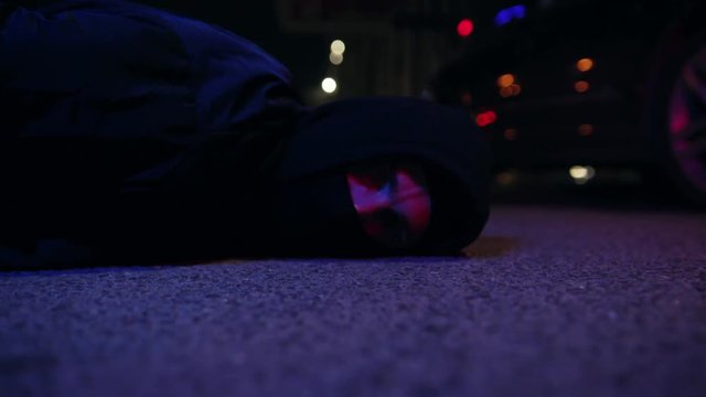Close up man ganster lying on ground police caught a bandit silen light in the dark at night police protection arrest balaclava crowbar dangerous defense handcuffs masked people person violence
