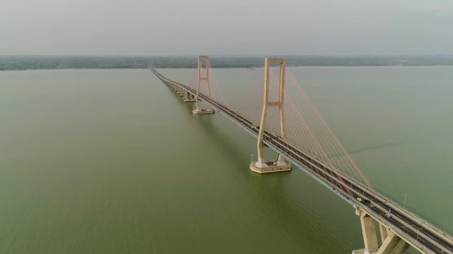 aerial view suspension cable bridge Suramadu over madura strait connecting islands Java and Madura. surabaya high coast bridge with highway. java, indonesia
