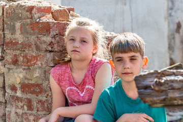 Poor orphans against the background of destroyed buildings, the concept of the life of street...