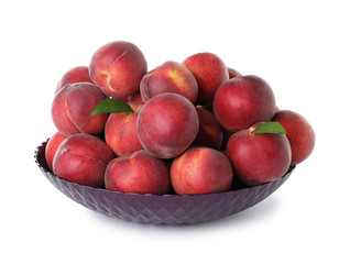 Bowl of delicious ripe peaches isolated on white