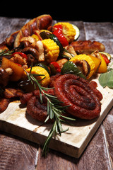 Assorted delicious grilled meat and skewer with vegetable on rustic table