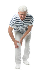 Full length portrait of senior man having knee problems on white background