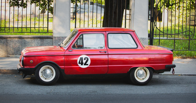 Red tuned retro car parked on the road