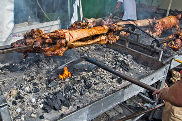 Roasting of young piglets on the grill and fire