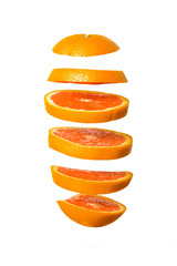 Naklejka na ściany i meble Creative concept with Flying orange. Sliced orange isolated on white background. Levity fruit floating in the air.