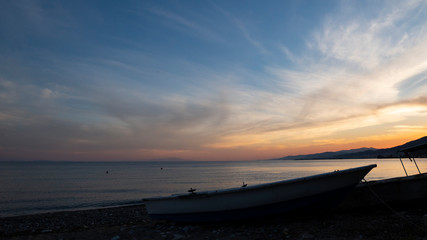 Sea ​​coast sunset and boat