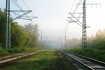 Fototapeta na wymiar railway tracks going into the fog