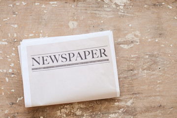 Obraz premium Newspaper and coffee on wooden background