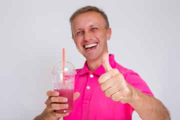 Closeup Portrait of Happy Caucasian Man with Smoothie Against White Showing Thumbs Up.Focus on Hand.