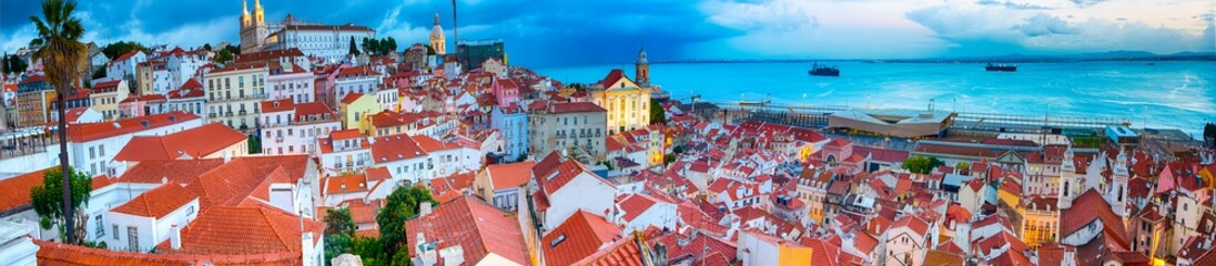 Fototapeta premium Panoramic Image of The Oldest Alfama District in Lisbon in Portugal. Townscape Scenery Was Made During a Blur Hour.