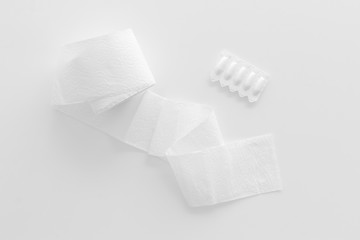 Toilet paper roll and rectal suppository for proctology diseases concept on white background top view