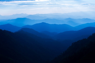 Majestic sunset sky over blue mountains layers landscape
