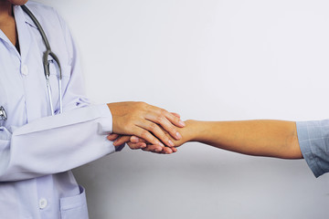 Hand of doctor reassuring her female patient,Partnership, trust and medical ethics concept. Bad news lessening and support. Patient cheering and support,Take care and trust concept,