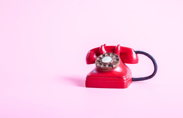 3D red telephone closeup on pink background