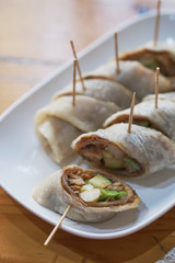 Plate with fresh spring rolls in rice paper on table